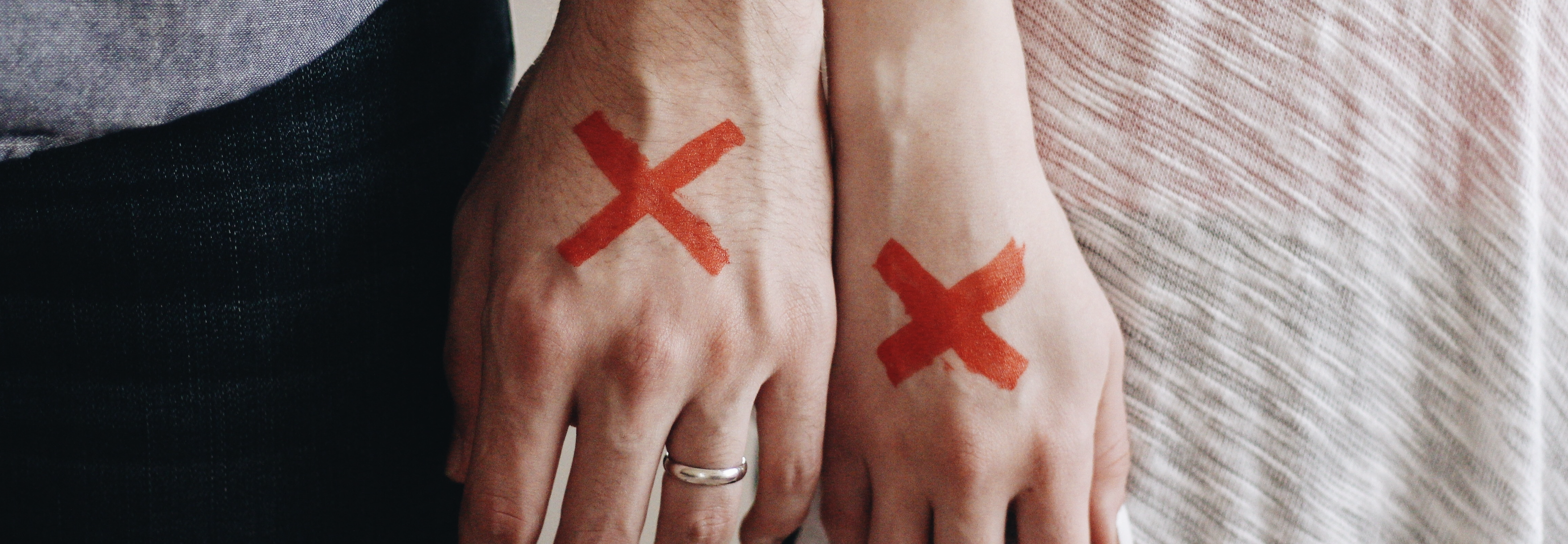 Image - man and woman hands marked with X