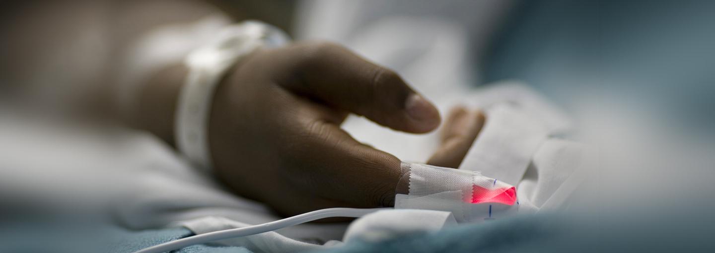Pandemic Health-Care Inequities: How They Put All Americans at Risk Image - photos of hospital patient's hand