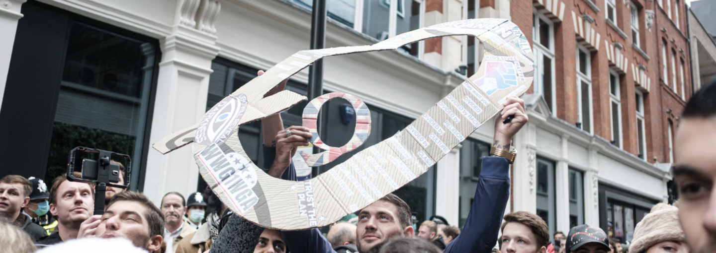 QAnon: What Happens Now? Image - protestor holding sign