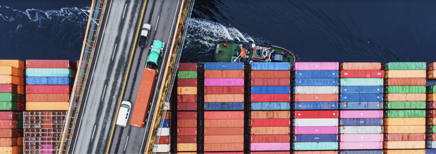 What the Infrastructure Deal Means for Climate Image - shipping freighter passing underneath a bridge