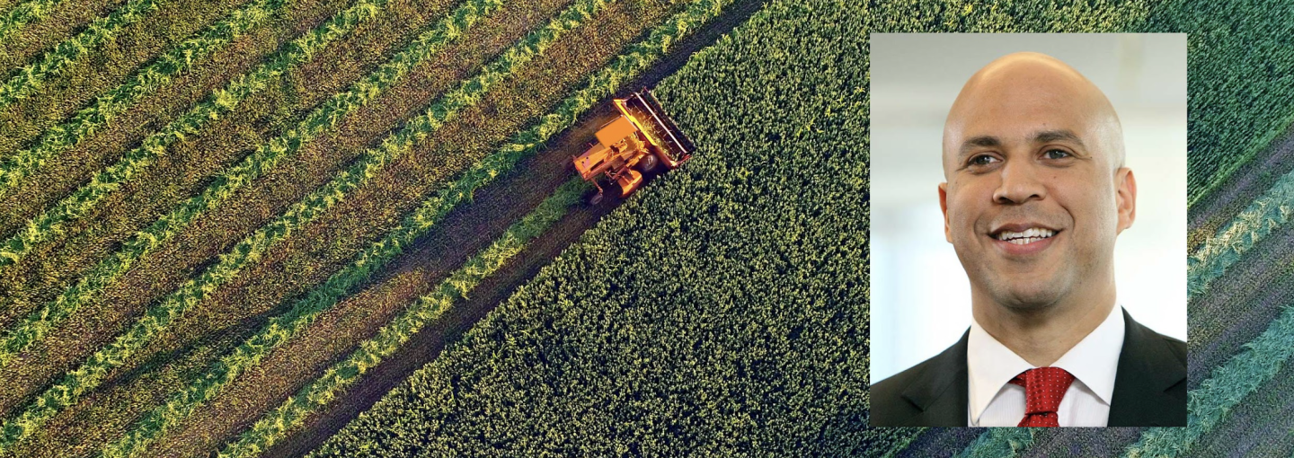 Cory Booker: Taking on Big Ag and Going Big on Climate Image - Cory Booker and a tractor on a farm