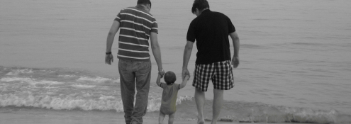 Image - two parents with baby on beach