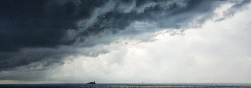 Image - ship in ocean, underneath storm clouds