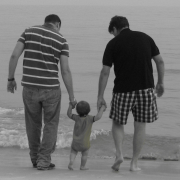 Gay Family Building Image - two parents with baby on beach