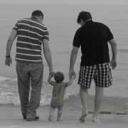 Image - two parents with baby on beach