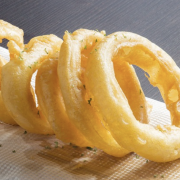 Grief Vampire: Operation Onion Ring Image - a row of onion rings on a wood serving board