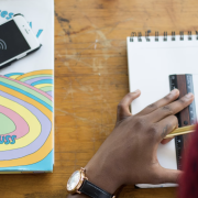 Image - student working with pencil, ruler and paper next to book and smarphone