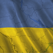 Ukraine Under Siege: What's Next Image - outline of Ukraine against backdrop of Ukrainian flag colors