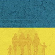 Helping Ukraine's Refugees Image - people against backdrop of Ukraine flag