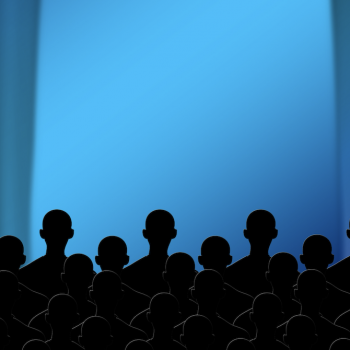 Image - rear view of audience members looking at stage curtains