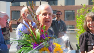 Image - George Dobbins holding flowers