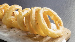 Image - a row of onion rings on a wood serving board