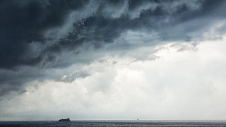 Image - ship in ocean, underneath storm clouds